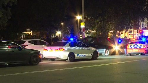 Police cars swarm the allegedly stolen black Range Rover.