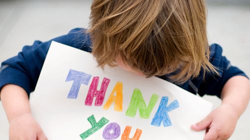 Boy holding Thank You sign