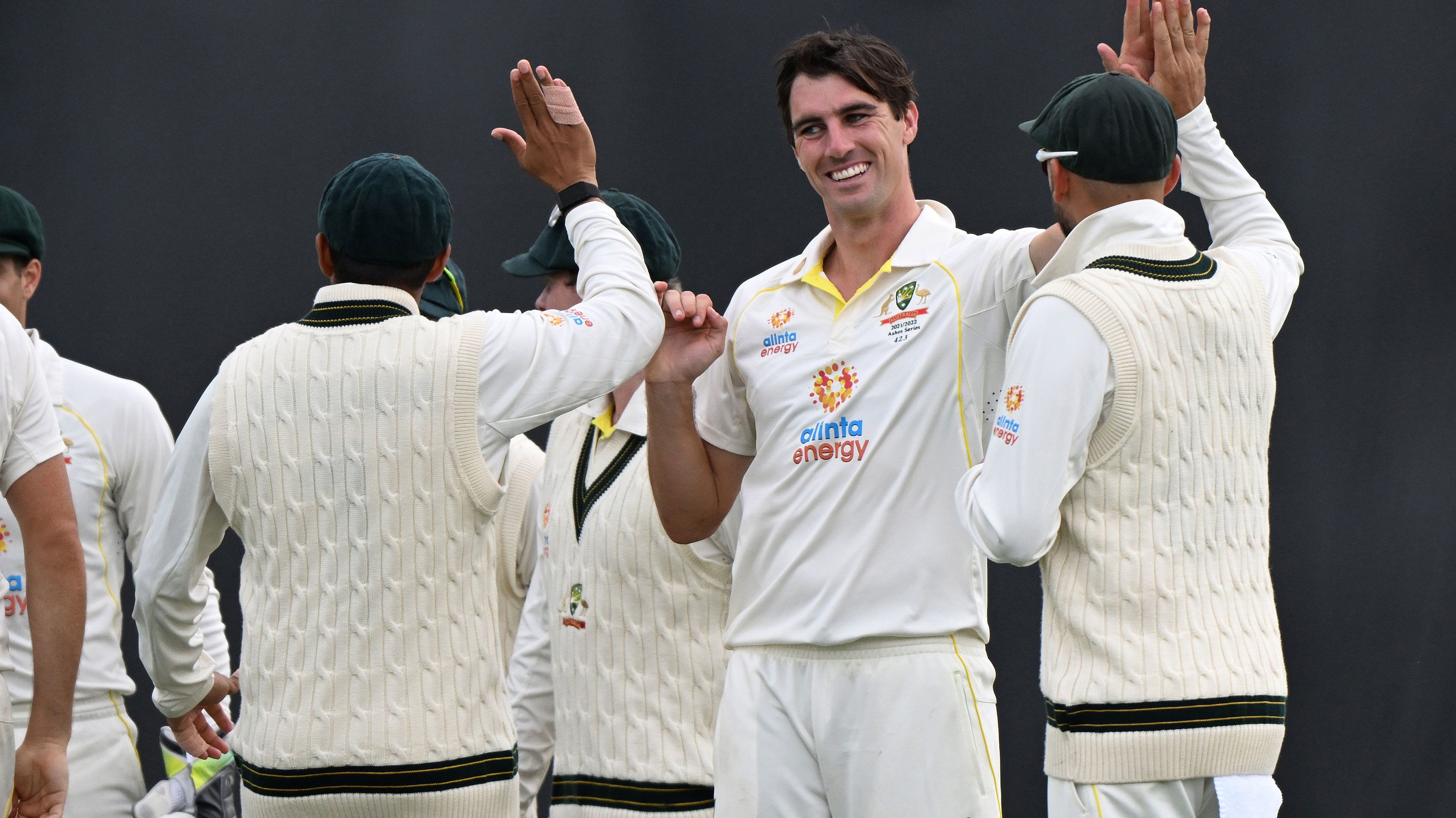 Pat Cummins celebrates with teammates after taking a wicket during day two of the fifth Test in the Ashes series between Australia and England at Blundstone Arena on January 15, 2022. 