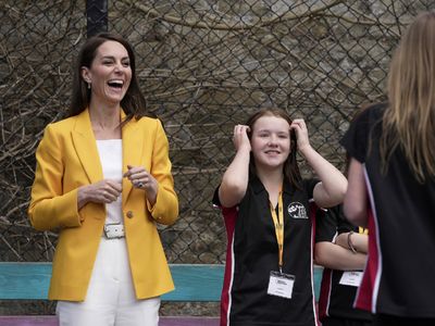 Kate stuns in yellow jacket and go-to sneakers