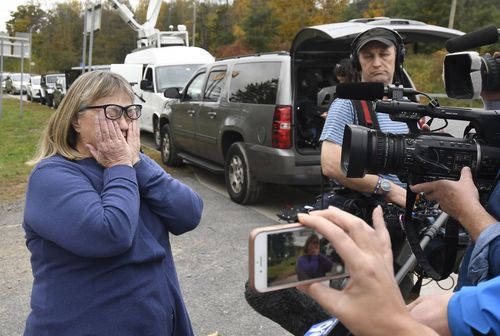 Barbara Douglas of Danamora, N.Y., reacts while talking about her four family members who died.