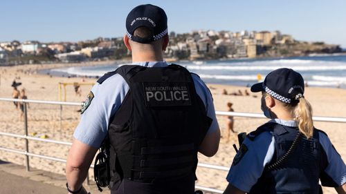 Police patrol Bondi Beach during Sydney's latest COVID-19 lockdown.