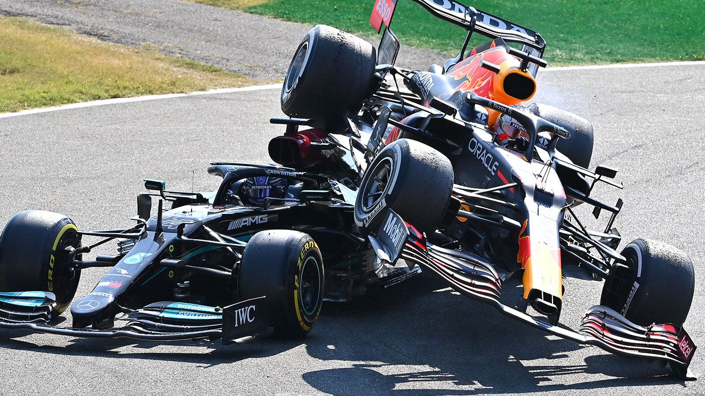 Max Verstappen of the Netherlands driving the (33) Red Bull Racing RB16B Honda and Lewis Hamilton of Great Britain driving the (44) Mercedes AMG Petronas F1 Team Mercedes W12 crash during the F1 Grand Prix of Italy at Autodromo di Monza on September 12, 2021 in Monza, Italy. (Photo by Peter Van Egmond/Getty Images)