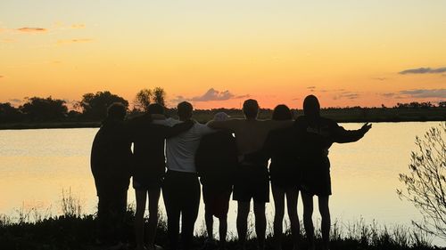 BackTrack participants watch a sunset over a lake.