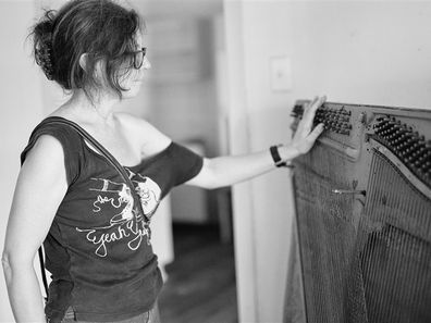 Rebecca Rushbrook assessing the heartbreaking loss of her 200 year old piano. 