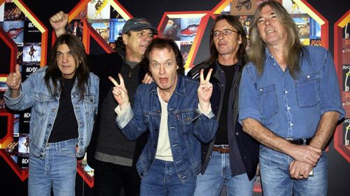 Malcolm Young, Brian Johnson, Angus Young, Phil Rudd and Cliff Williams from AC/DC pose for photographers in March 2003. (AAP)