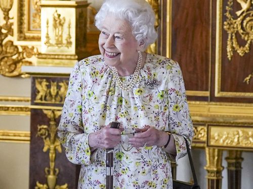 WINDSOR, ENGLAND - MARCH 23: Queen Elizabeth II arrives to view a display of artefacts from British craftwork company, Halcyon Days, to commemorate the company's 70th anniversary in the White Drawing Room at Windsor Castle, on March 23, 2022 in Windsor, England. The Queen viewed a selection of hand-decorated archive enamelware and fine bone china, including their earliest designs from the 1950s. (Photo Steve Parsons - WPA Pool/Getty Images)