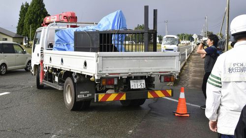 Bears in cages placed on a truck are taken out of a factory in Misato, Akita prefecture.