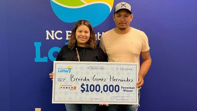 Brenda Gomez Hernandez is pictured with the $100,000 Powerball prize she won on the same day she gave birth.