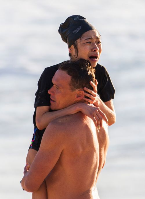 The terrified swimmer was carried from the beach in Andrew Reid's arms.