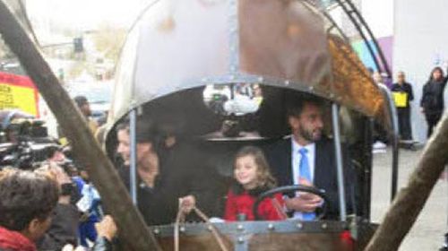 Libby Schaaf in her snail shaped car with her family at Oakland's Paramount Theater.