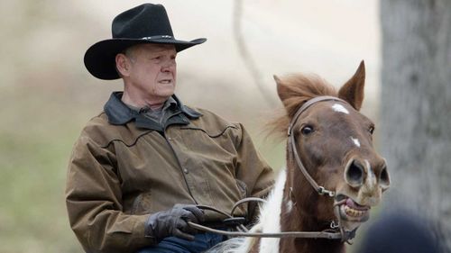 Roy Moore rides his horse to the polling station in Gallant, Alabama. (AAP)