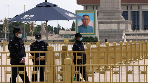 Chinese security personnel wearing masks stand guard near a portrait of Sun Yat-sen, who is widely regarded as the founding father of modern China, on Tiananmen Square on Thursday, April 28, 2022, in Beijing. 