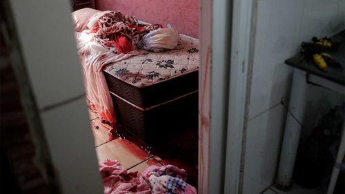 Blood covers the floor and a bed inside a home during a police operation targeting drug traffickers in the Jacarezinho favela of Rio de Janeiro, Brazil.