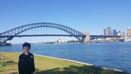 Flat Caleb "poses" with the Sydney Harbour Bridge and Opera House behind him. (Facebook/Harbourside LAC – NSW Police Force)