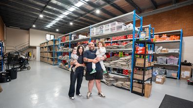 The Kozma family pose together inside one of the Waves Never Die warehouses.