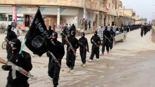 This undated photo published in 2014 shows IS militants marching in the capital Raqqa. (AAP)