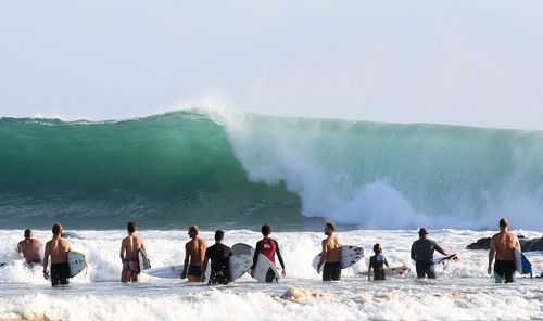 Snapper Rocks surfers survey the big swell. (AAP)