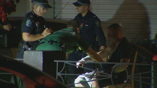 Paramedics treat one of the injured men.