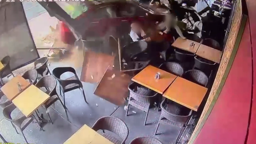 C﻿CTV footage has shown the moment a car has smashed into a busy cafe in Sydney's west, injuring several people and sending tables and chairs flying. 