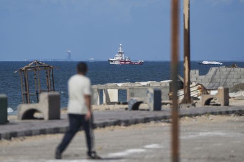 A ship belonging to the Open Arms aid group approaches the shores of Gaza towing a barge with 200 tons of humanitarian aid on Friday, March 15, 2024.