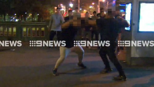 Two police officers suffered minor injuries during the riots. (9NEWS)