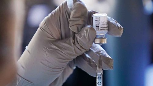 A vial of the Pfizer vaccine is prepared for use.