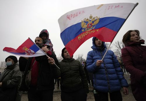 Supporters of Serbia's Novak Djokovic wave a Russian, right, and Serbian flags during a protest in Belgrade, Serbia, Saturday, Jan. 8, 2022.