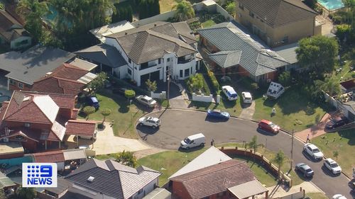 T﻿wo women have been arrested and an alleged underworld figure is on the run after police searched a home in Sydney's south west.