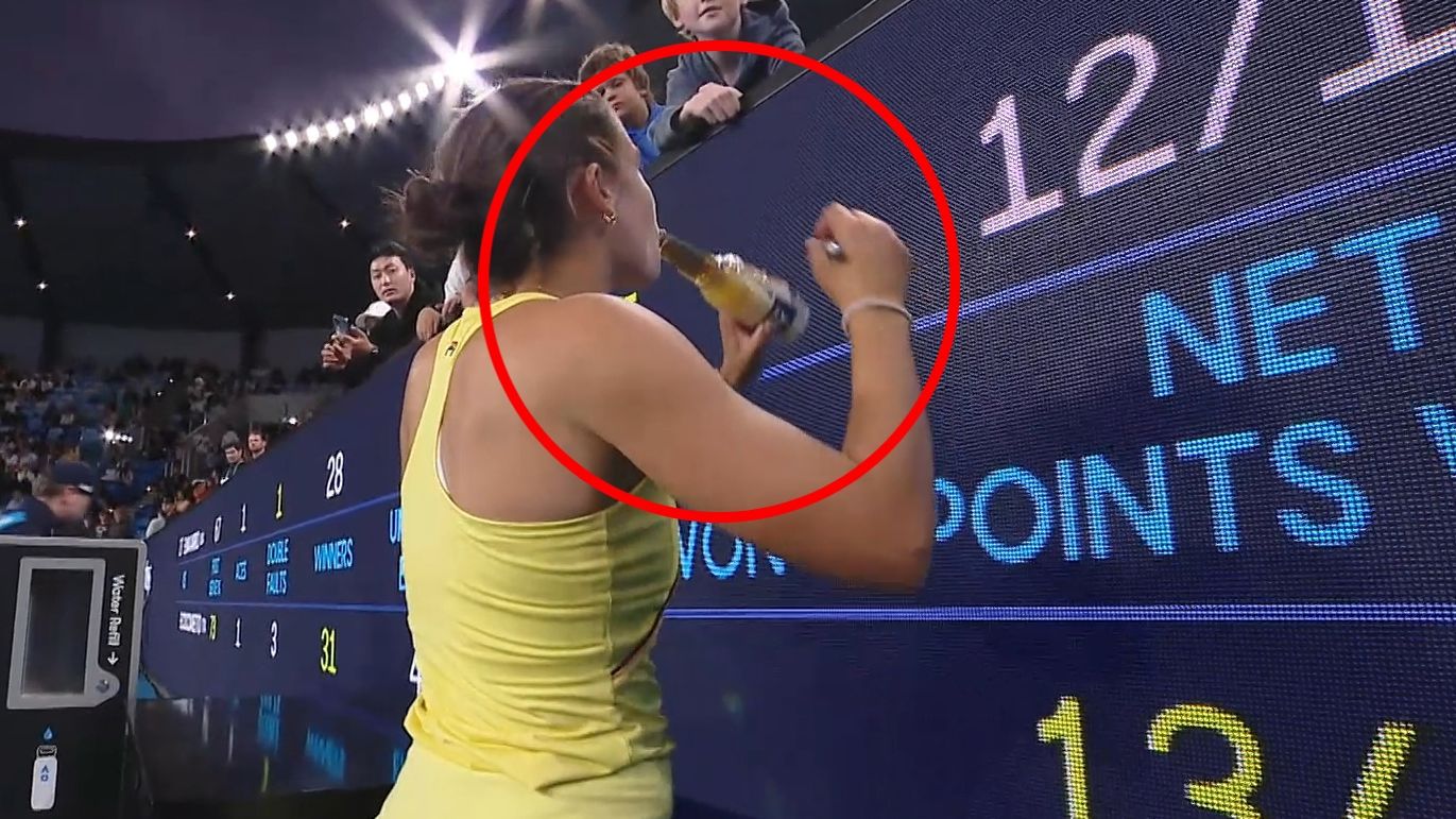 Emma Navarro takes a swing of a punter&#x27;s beer courtside.