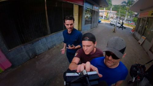 Danny Nikolic, the brother of a man facing drugs charges in Fiji, grabs the news camera. Picture: ACA