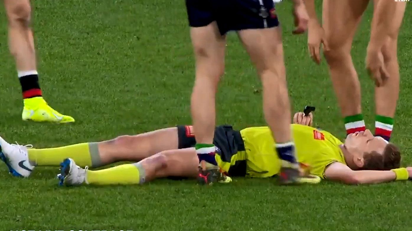 AFL umpire floored by brutal collision with Fremantle star in heated clash agaisnt Essendon