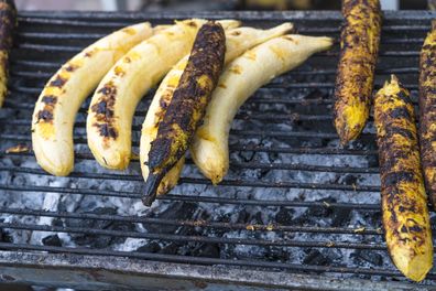Small bunch of bananas cooking on grill