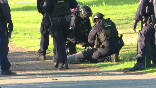 Police arrested the man after he surrendered to officers this afternoon.