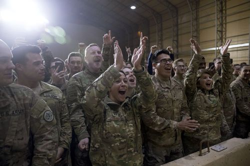 US troops applaud following the President's talk.