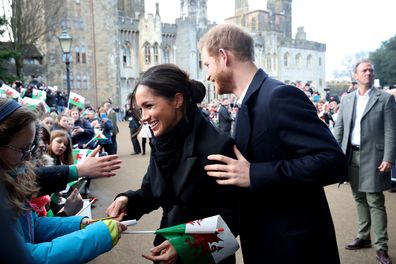 Prince Harry and Meghan Markle sign autographs and shake hands with children as they arrive to a walkabout at Cardiff Castle on January 18, 2018 in Cardiff, Wales.  (Photo by Chris Jackson/Chris Jackson/Getty Images)