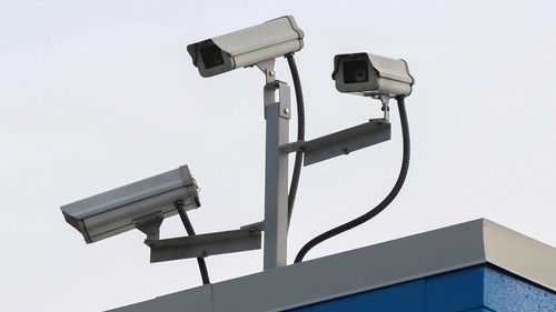 Cameras are seen outside of the Walmart store in Kennesaw, Georgia, that Mahendra "Mick" Patel visited seeking Tylenol for his mother.
