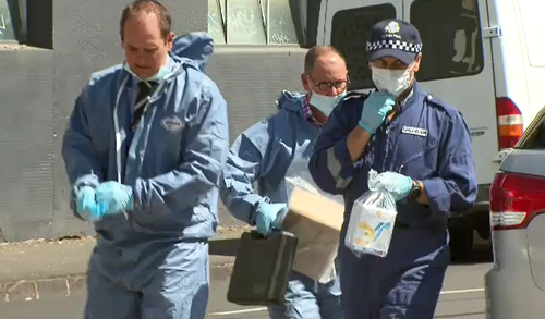 Forensic officers remove evidence from the Brunswick home. (9NEWS)