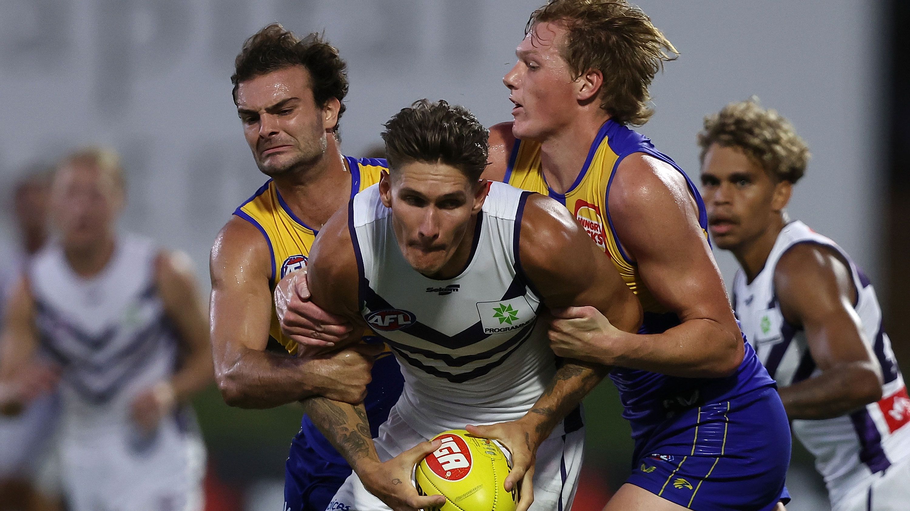Rory Lobb of the Dockers looks to break from a tackle by Jack Petruccelle and Hugh Dixon of the Eagles during a practice match.