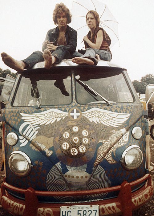 Concert-goers sit on the roof of a Volkswagen bus at the Woodstock Music and Arts Fair at Bethel, New York. The three-day concert attracted hundreds of thousands of people, and became a landmark cultural event of the late '60s.