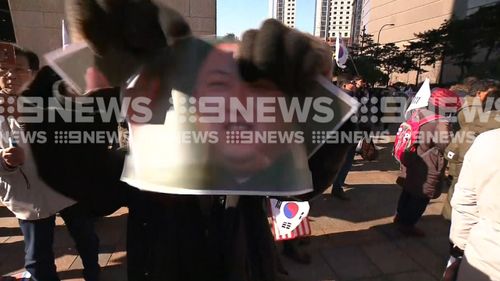 Images of Mr Kim were also torn up. (9NEWS)