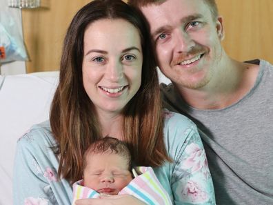 Felicity and Alex Jacques with baby born after being rescued from floods. 