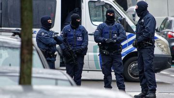 Anti-terrorist squad is seen in Molenbeek, near Brussels. (AAP)