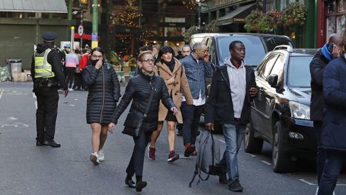 Police evacuate people from Borough Market on the south side of London Bridge in London, Friday, Nov. 29, 2019