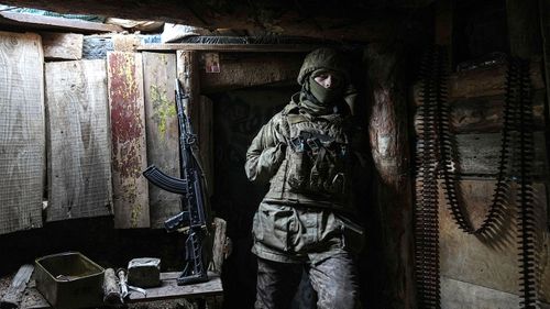 A Ukrainian serviceman stands in a shelter near Zolote