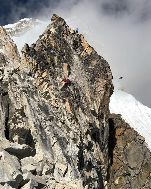 One day before the summit attempt, Michael Davis' group crosses the yellow tower of Mt Ama Dablam.
