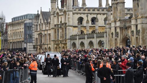 Crowds watch as the funeral cortege of Professor Stephen Hawking arrives. (EPA)