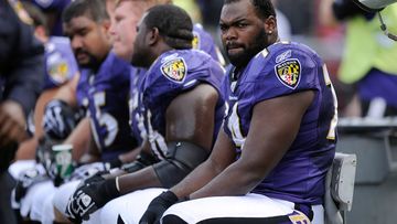 Baltimore Ravens offensive tackle Michael Oher sits on the bench 