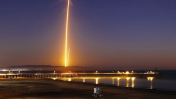 Two streaks in this long exposure photo show a SpaceX Falcon 9 rocket lifting off, left, from Vandenberg Air Force Base, as seen from Pismo Beach