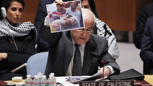 Palestinian envoy to UN holds up photos of slain children in ceasefire plea